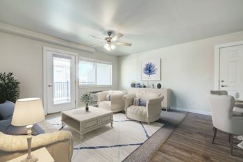 a living room with white furniture and a ceiling fan  at Madison Park, Bozeman, 59718